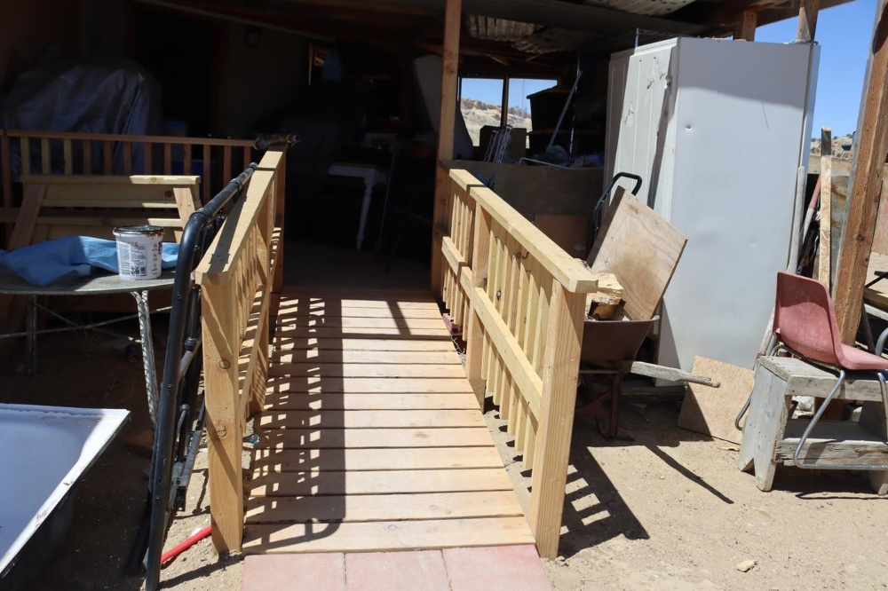 Wooden ramp installed outside of entrance of home