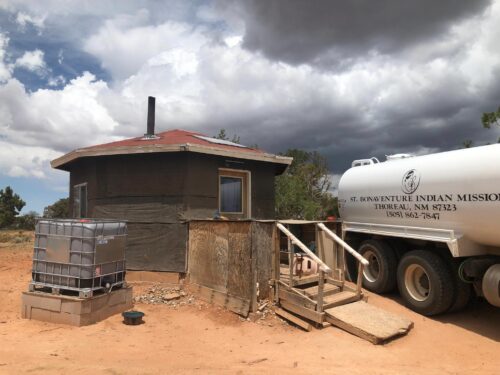 A water delivery truck labeled 
